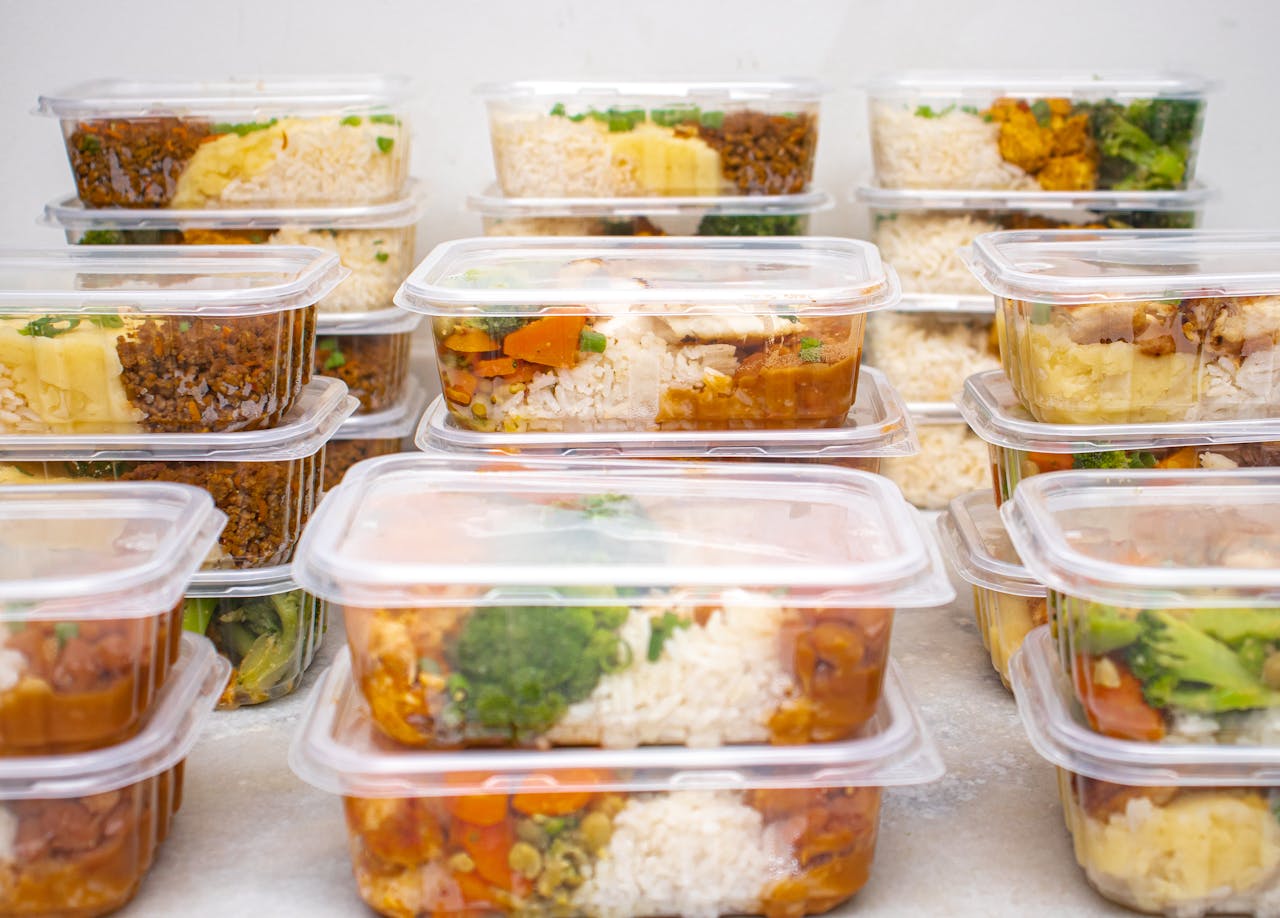 about-03 Multiple containers of prepared meals with rice and vegetables for easy meal management.