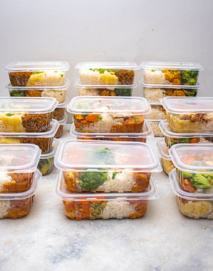Organized meal prep containers filled with rice and vegetables for healthy eating.